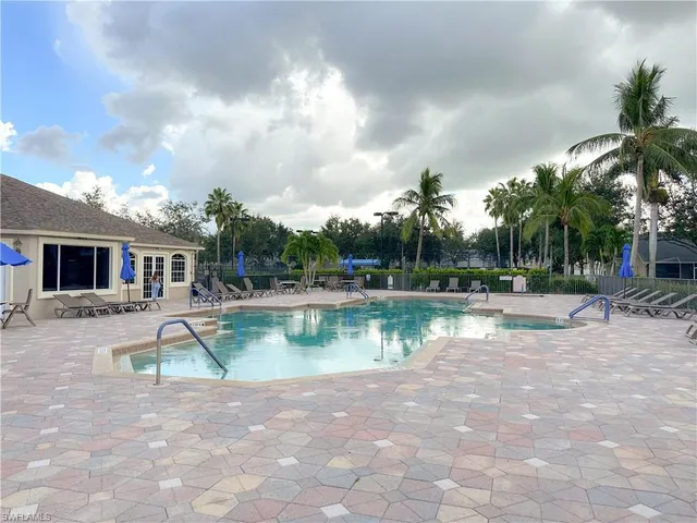 an aerial view of a house with a swimming pool outdoor seating and yard