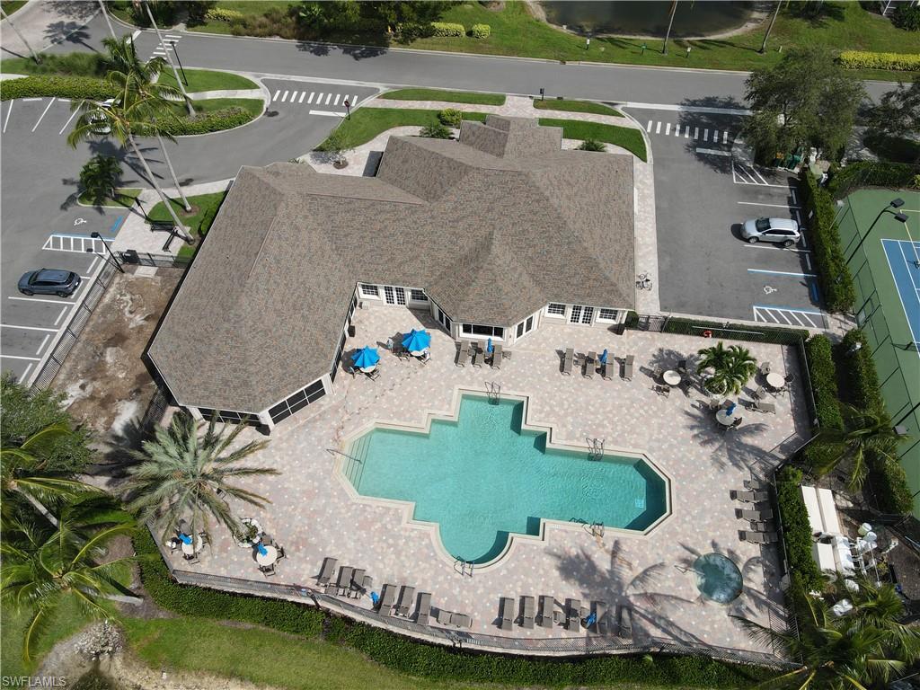 8220 Ibis Cove Circle, Unit B216 Naples, FL 34119 - Photo 26 of 34 an aerial view of a house with a swimming pool outdoor seating and yard