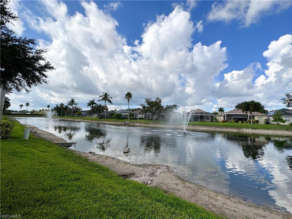 8220 Ibis Cove Circle, Unit B216 Naples, FL 34119 - Photo 33 of 34 a view of a lake with houses