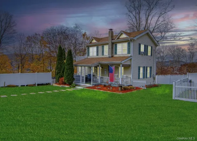 a view of a building with a yard and sitting area