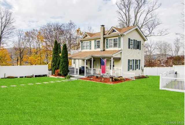 a view of a house with garden and sitting area