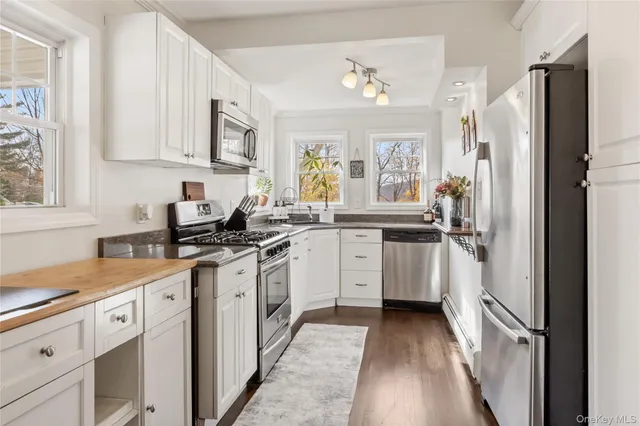 a kitchen with white cabinets and white appliances