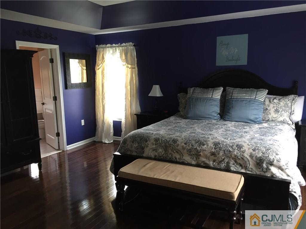 20 Carnation Road Monroe Township, NJ 08831 - Photo 15 of 23 a bedroom with a bed and a lamp on desk