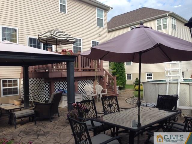 20 Carnation Road Monroe Township, NJ 08831 - Photo 19 of 23 a view of a patio with a table and chairs under an umbrella