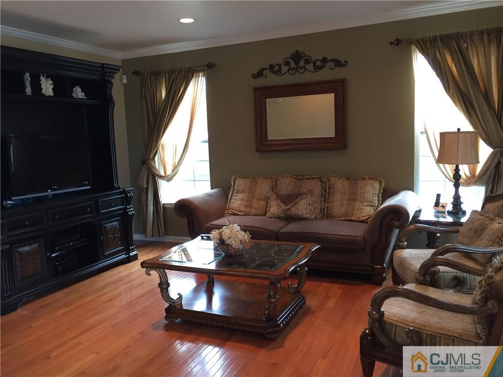 20 Carnation Road Monroe Township, NJ 08831 - Photo 3 of 23 a living room with furniture and a flat screen tv
