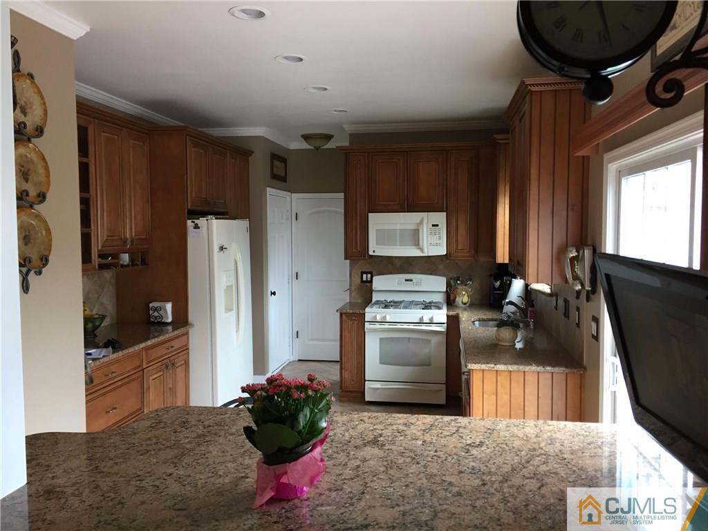 20 Carnation Road Monroe Township, NJ 08831 - Photo 6 of 23 a kitchen with refrigerator and cabinets