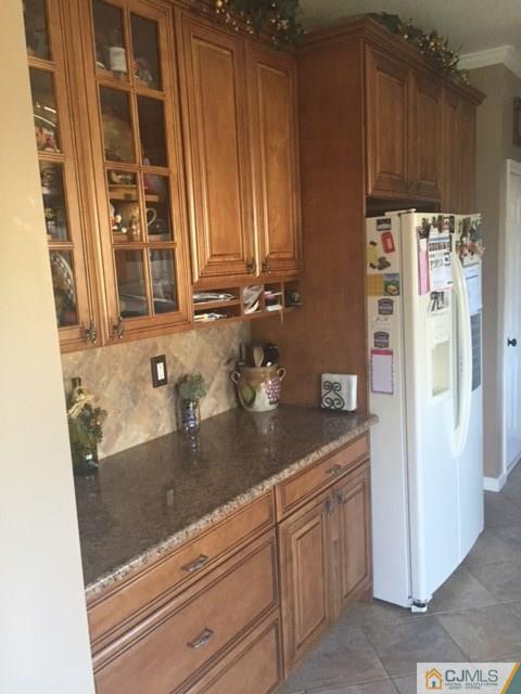20 Carnation Road Monroe Township, NJ 08831 - Photo 7 of 23 a kitchen with granite countertop stainless steel appliances a refrigerator and cabinets