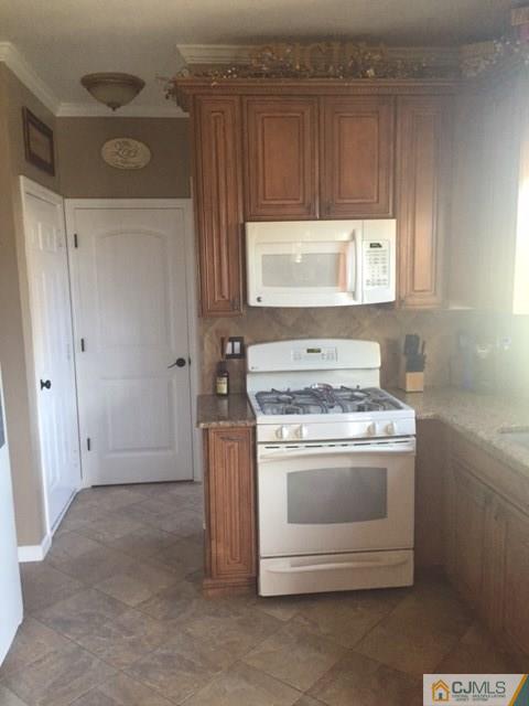 20 Carnation Road Monroe Township, NJ 08831 - Photo 8 of 23 a stove top oven sitting inside of a kitchen