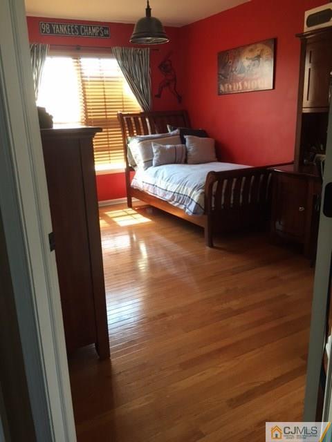 20 Carnation Road Monroe Township, NJ 08831 - Photo 10 of 23 a bedroom with a bed and wooden floor