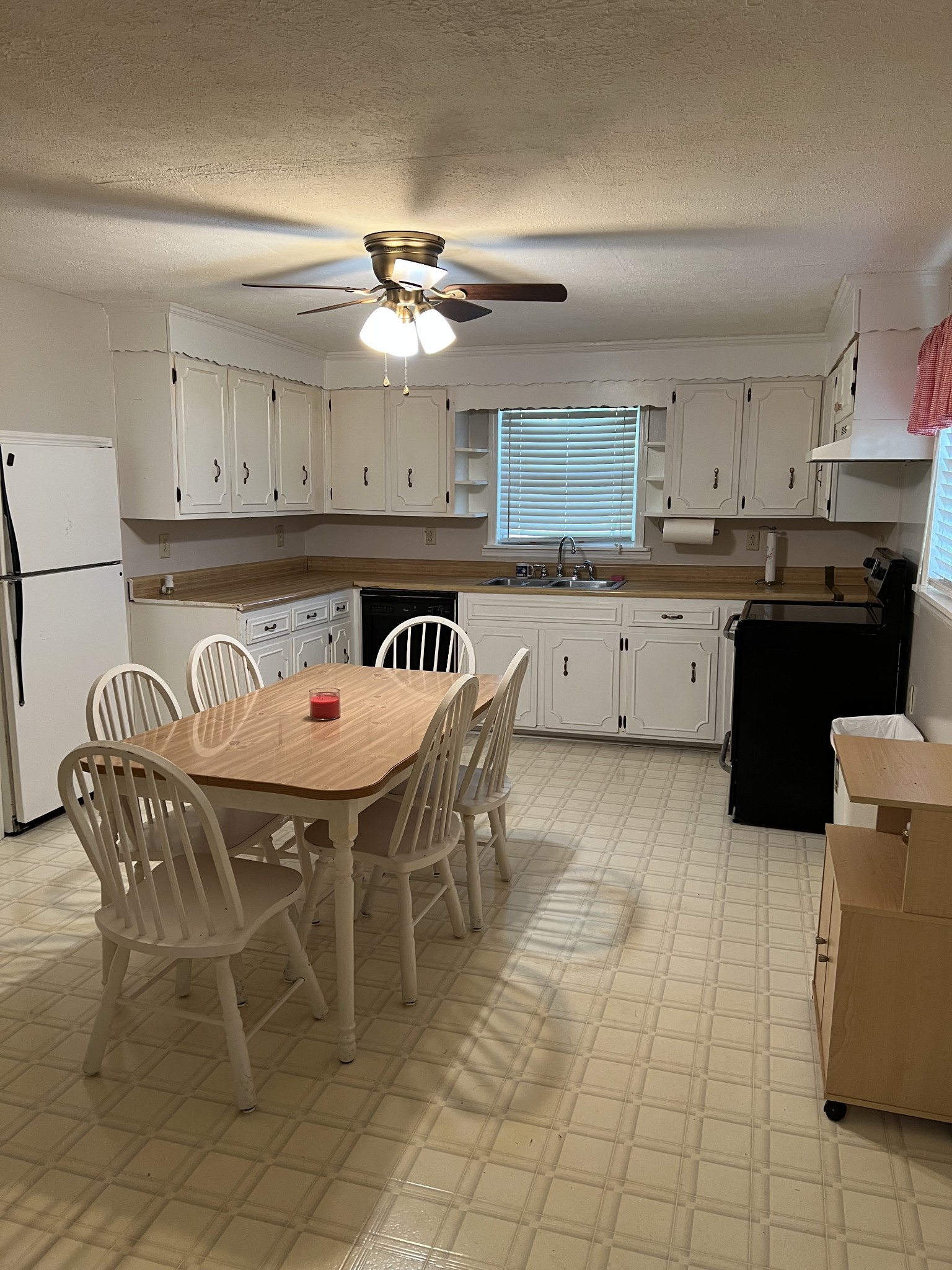 272 Clubbs Road Portland, TN 37148 - Photo 10 of 29 a kitchen with a sink a stove a dining table and chairs
