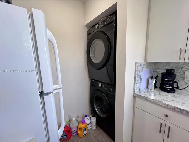 a kitchen with granite countertop kitchen island stainless steel appliances a sink and a stove