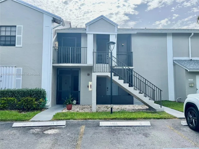 a living room with furniture ceiling fan and a rug