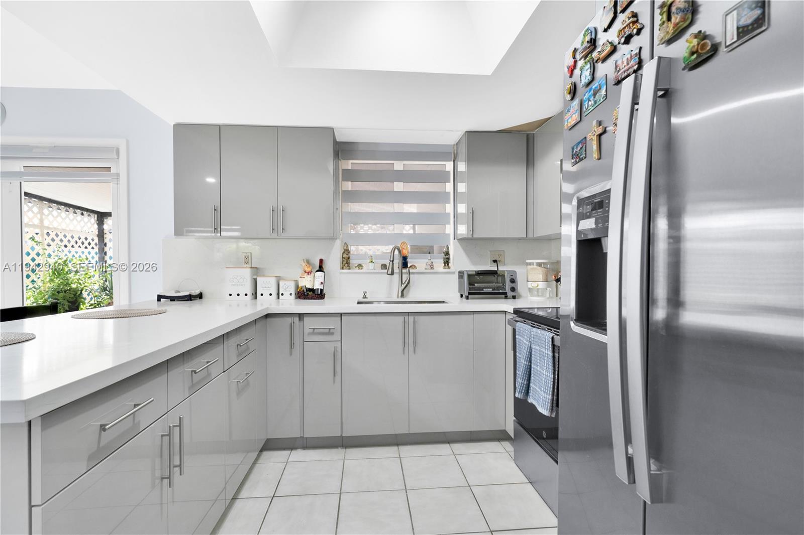 1142 Southwest 138th Court Miami, FL 33184 - Photo 16 of 50 a kitchen with a sink window and cabinets