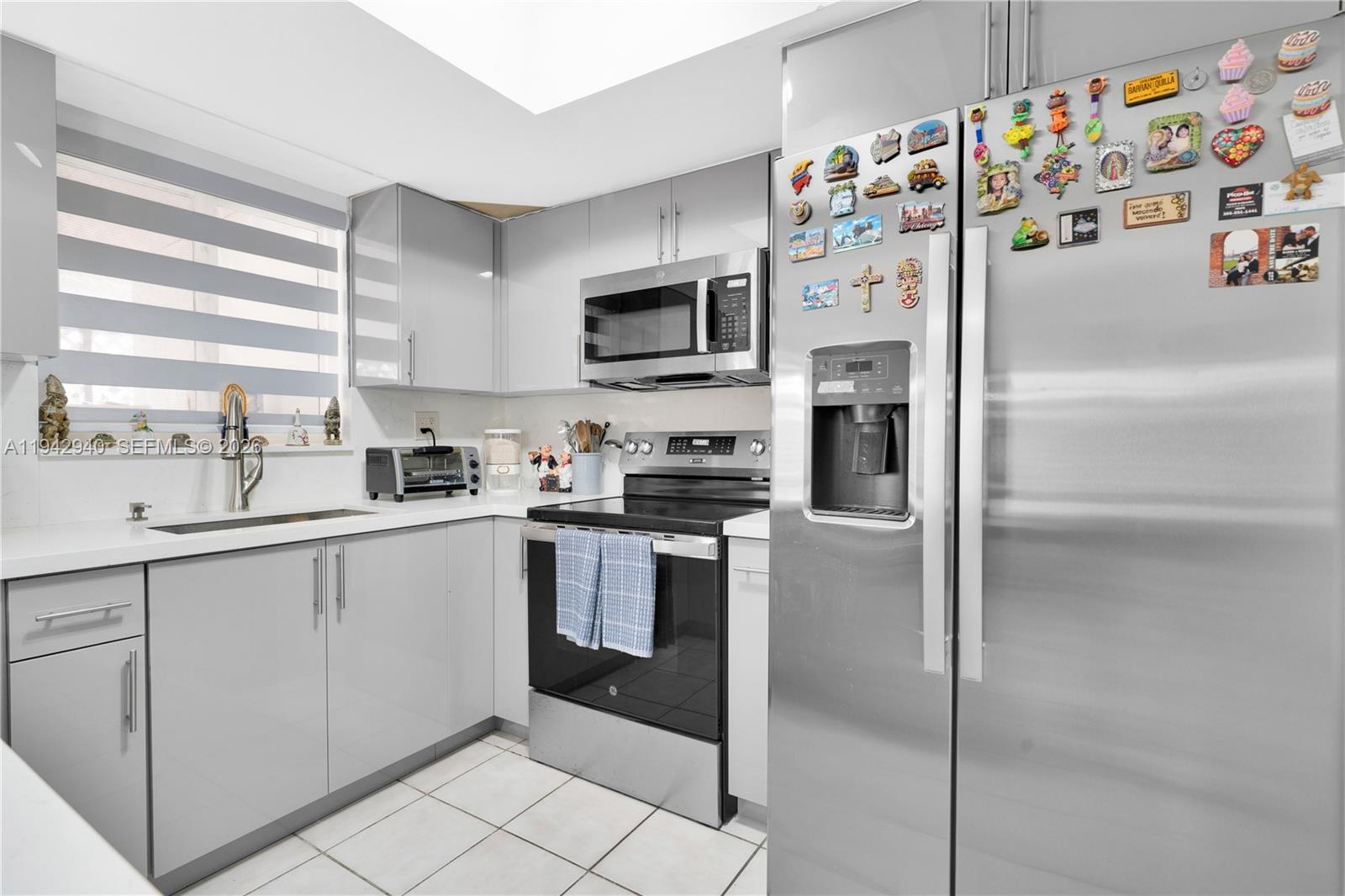 1142 Southwest 138th Court Miami, FL 33184 - Photo 17 of 50 a kitchen with stainless steel appliances a refrigerator sink and microwave