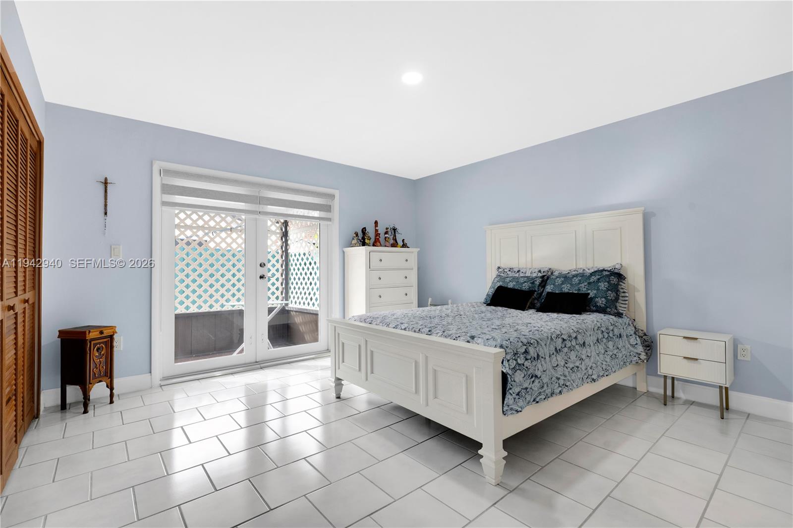 1142 Southwest 138th Court Miami, FL 33184 - Photo 20 of 50 a bedroom with a bed and a table in it