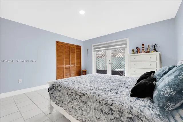 a bedroom with a bed window and dresser