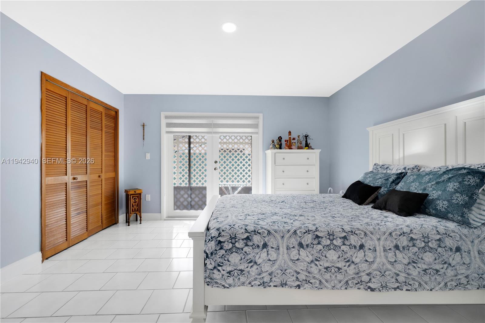 1142 Southwest 138th Court Miami, FL 33184 - Photo 22 of 50 a bedroom with a large bed and a dresser