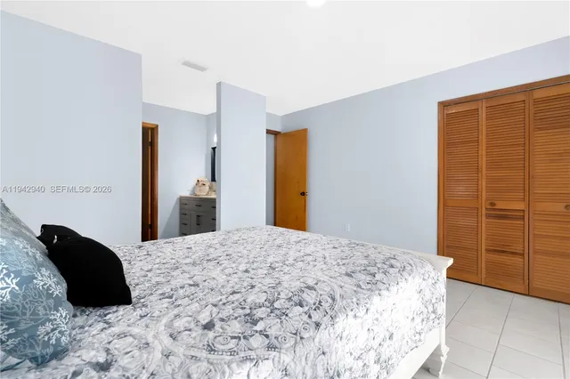 a bedroom with a bed and cabinets