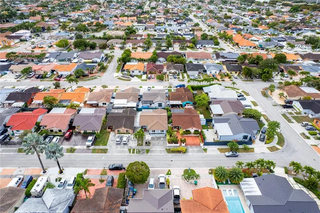an aerial view of residential houses with outdoor space
