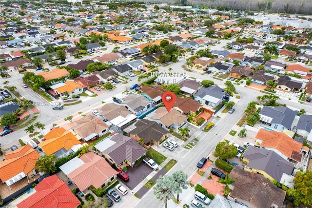 an aerial view of residential houses with outdoor space