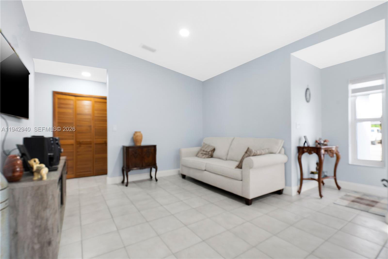 1142 Southwest 138th Court Miami, FL 33184 - Photo 6 of 50 a living room with furniture and a flat screen tv