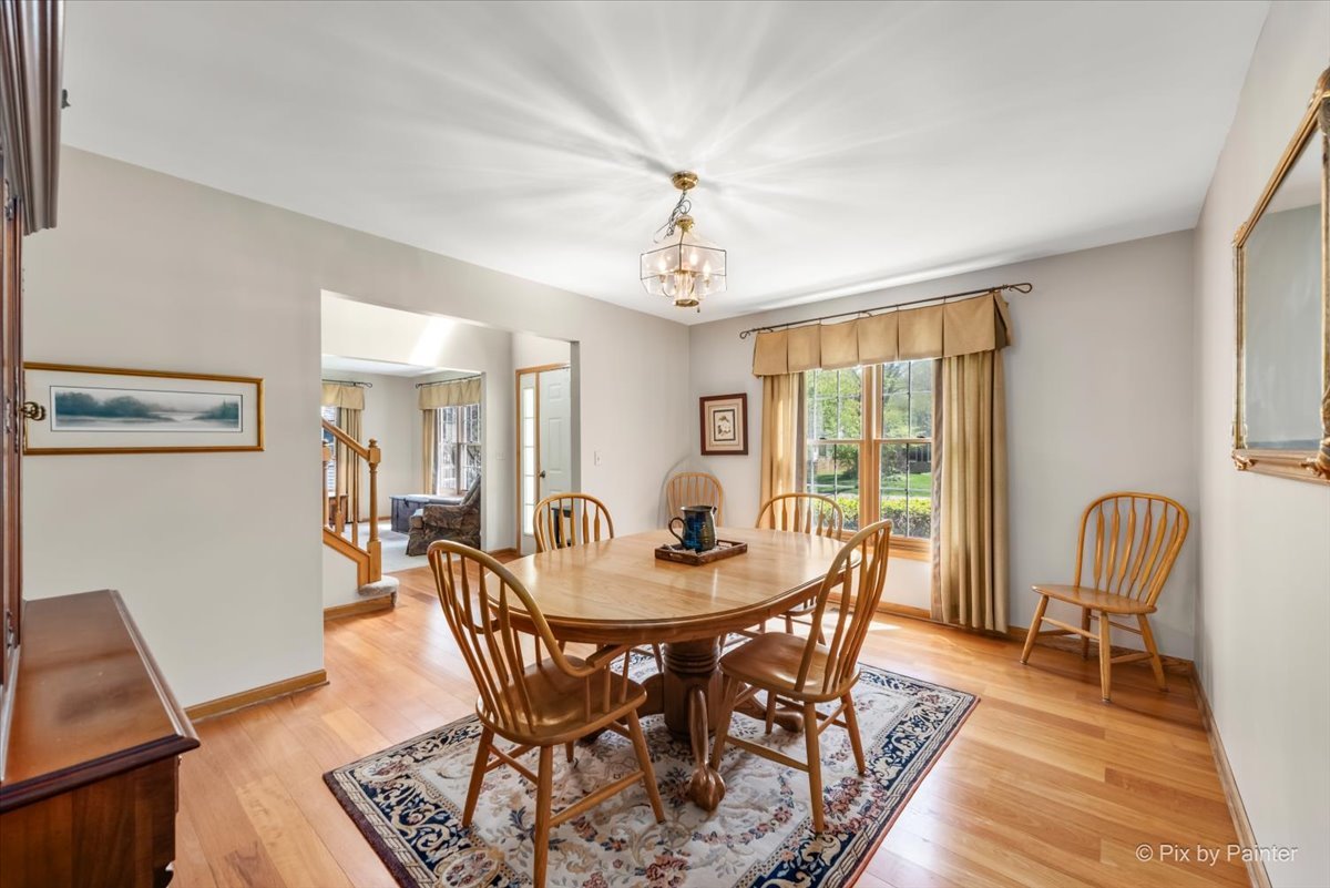 121 Hampton Street Cary, IL 60013 - Photo 11 of 56 a dining room with furniture a chandelier and wooden floor