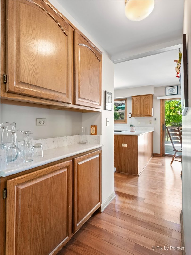 121 Hampton Street Cary, IL 60013 - Photo 13 of 56 a kitchen with stainless steel appliances granite countertop a sink and cabinets with wooden floor