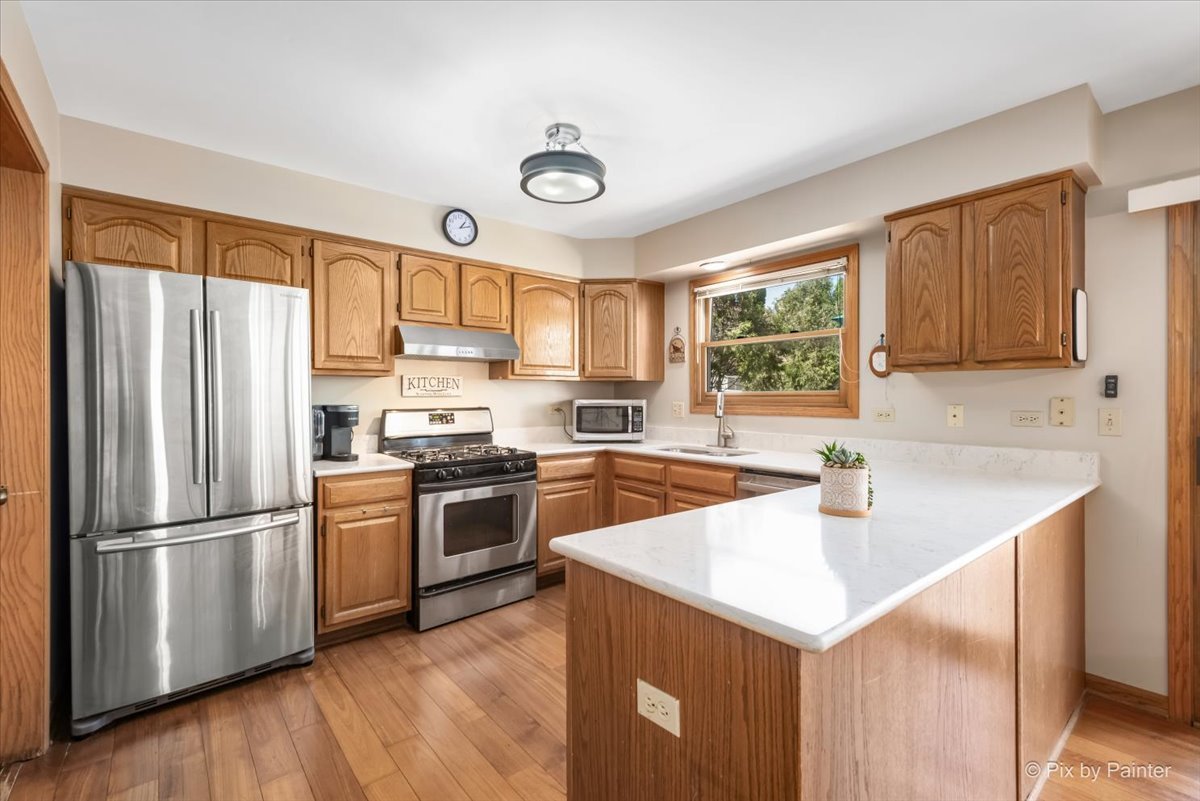 121 Hampton Street Cary, IL 60013 - Photo 16 of 56 a kitchen with a refrigerator sink and cabinets
