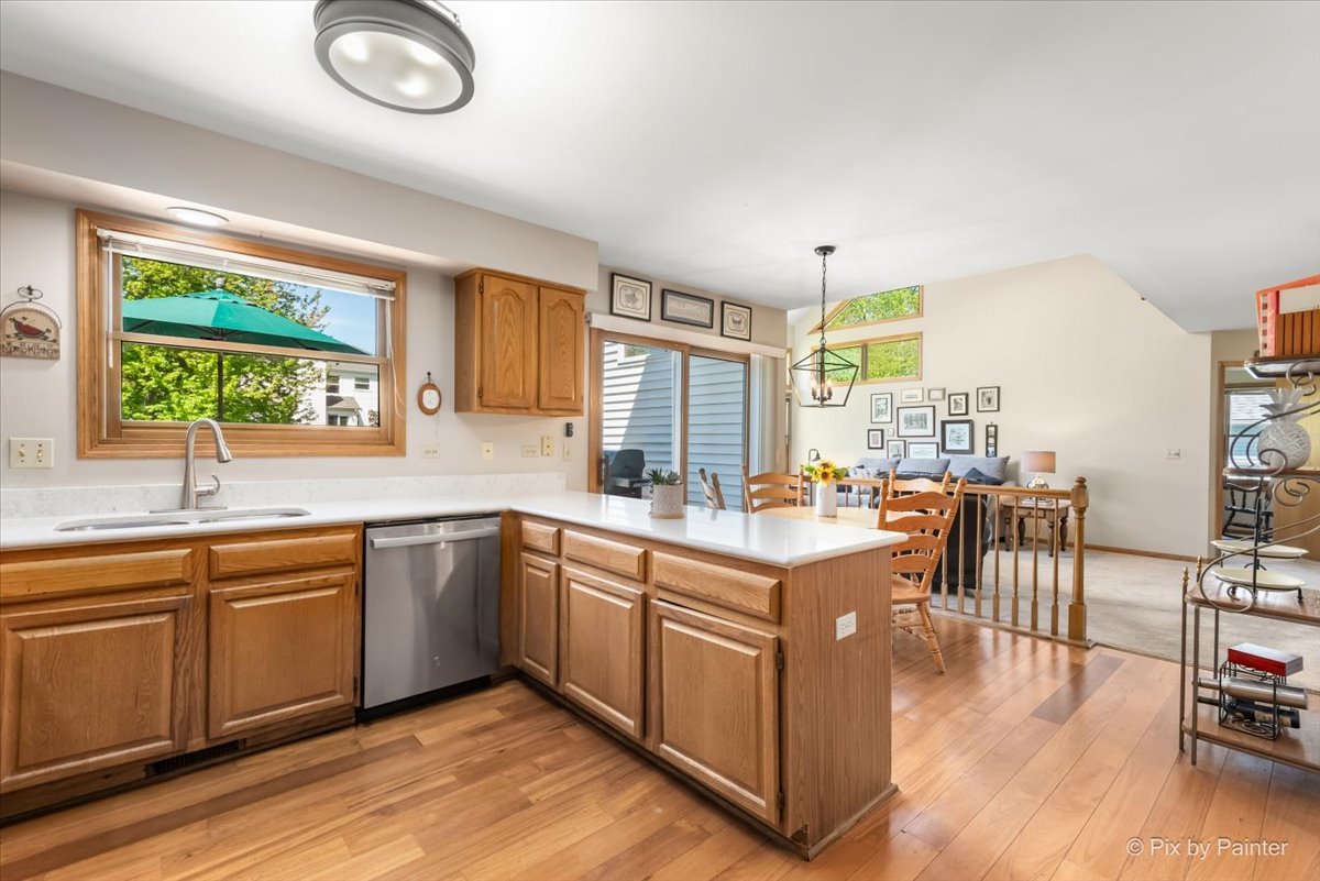 121 Hampton Street Cary, IL 60013 - Photo 18 of 56 a large kitchen with cabinets chairs and wooden floor