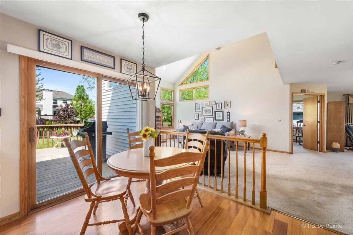 121 Hampton Street Cary, IL 60013 - Photo 19 of 56 a dining room with furniture a chandelier and wooden floor