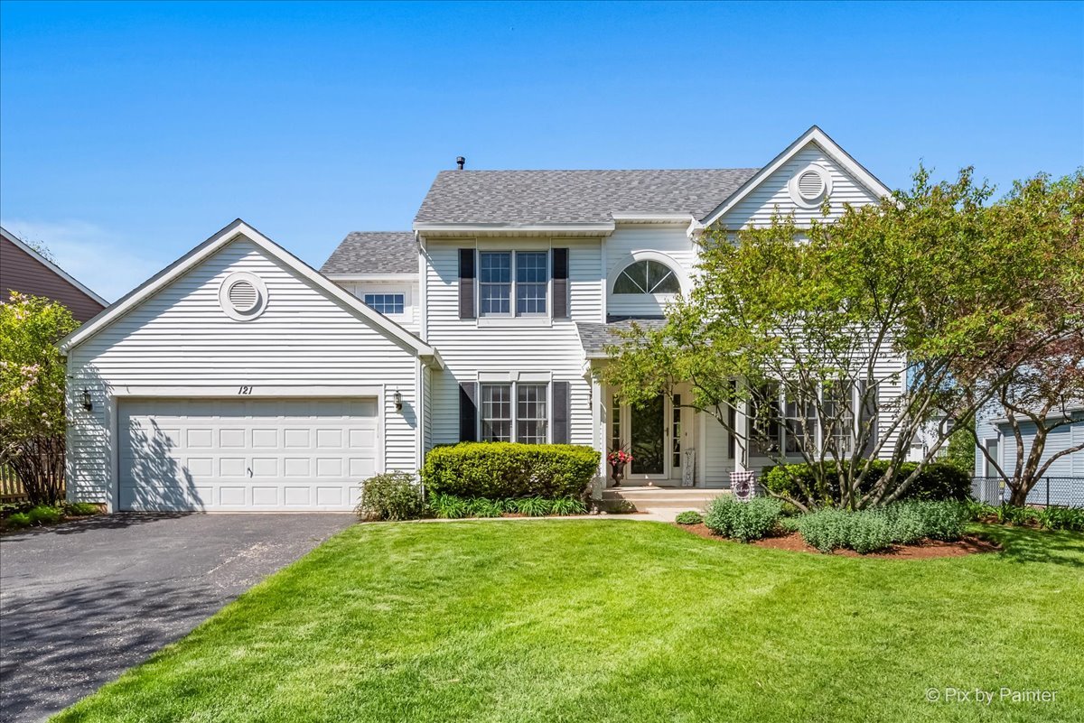 121 Hampton Street Cary, IL 60013 - Photo 2 of 56 a front view of a house with a yard and garage