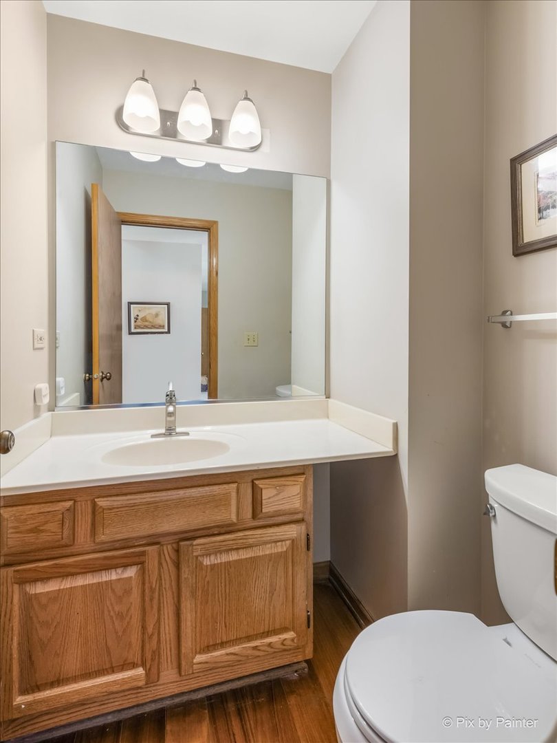 121 Hampton Street Cary, IL 60013 - Photo 25 of 56 a bathroom with a toilet a sink and wooden floor