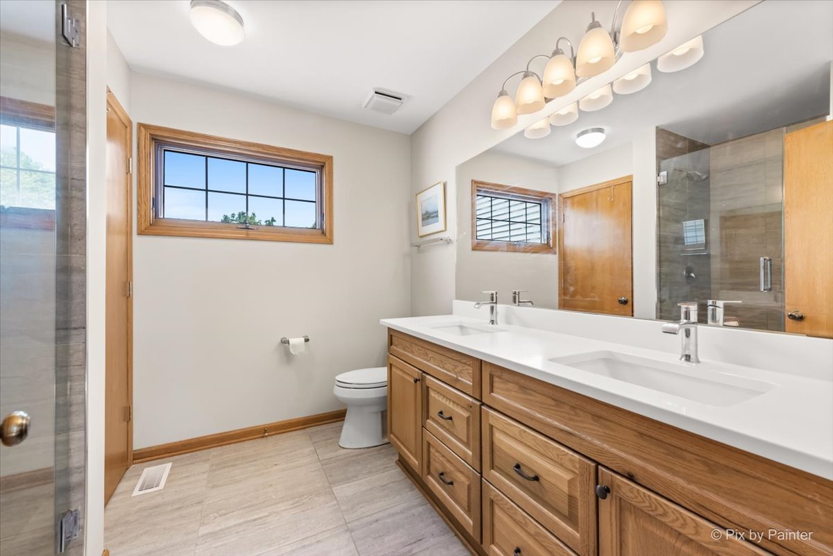 121 Hampton Street Cary, IL 60013 - Photo 29 of 56 a bathroom with a double vanity sink a mirror and a toilet