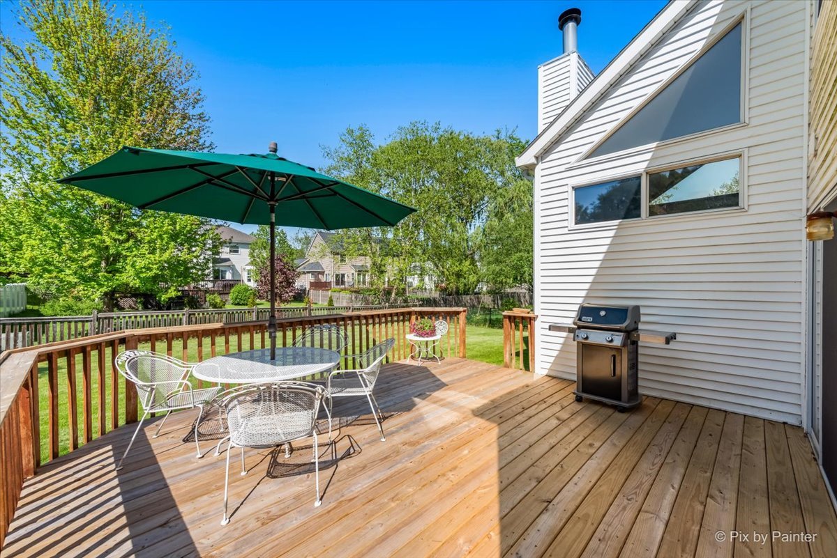 121 Hampton Street Cary, IL 60013 - Photo 41 of 56 a view of a chair and tables on the wooden deck
