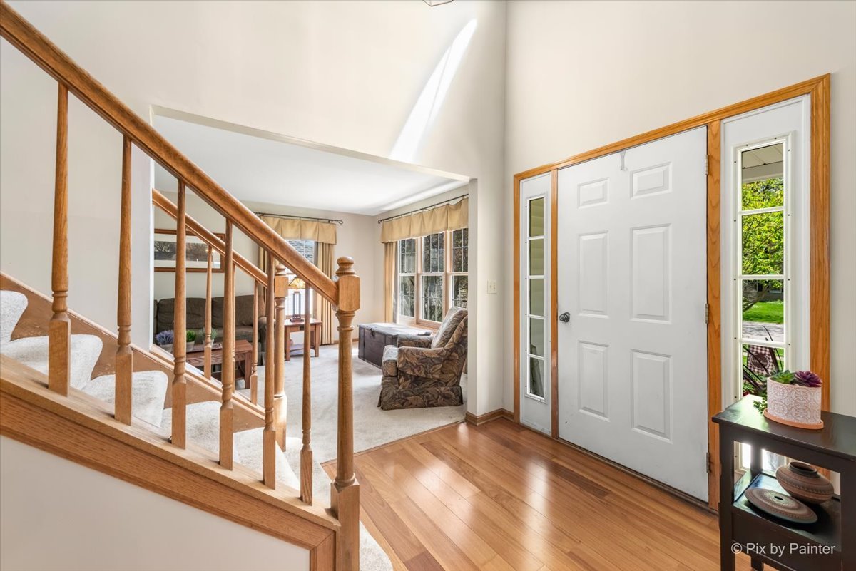 121 Hampton Street Cary, IL 60013 - Photo 7 of 56 a view of an entryway with wooden floor and windows