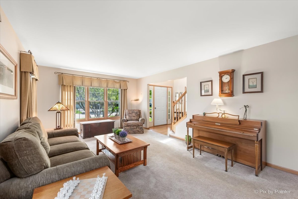 121 Hampton Street Cary, IL 60013 - Photo 9 of 56 a living room with furniture a rug and a large window