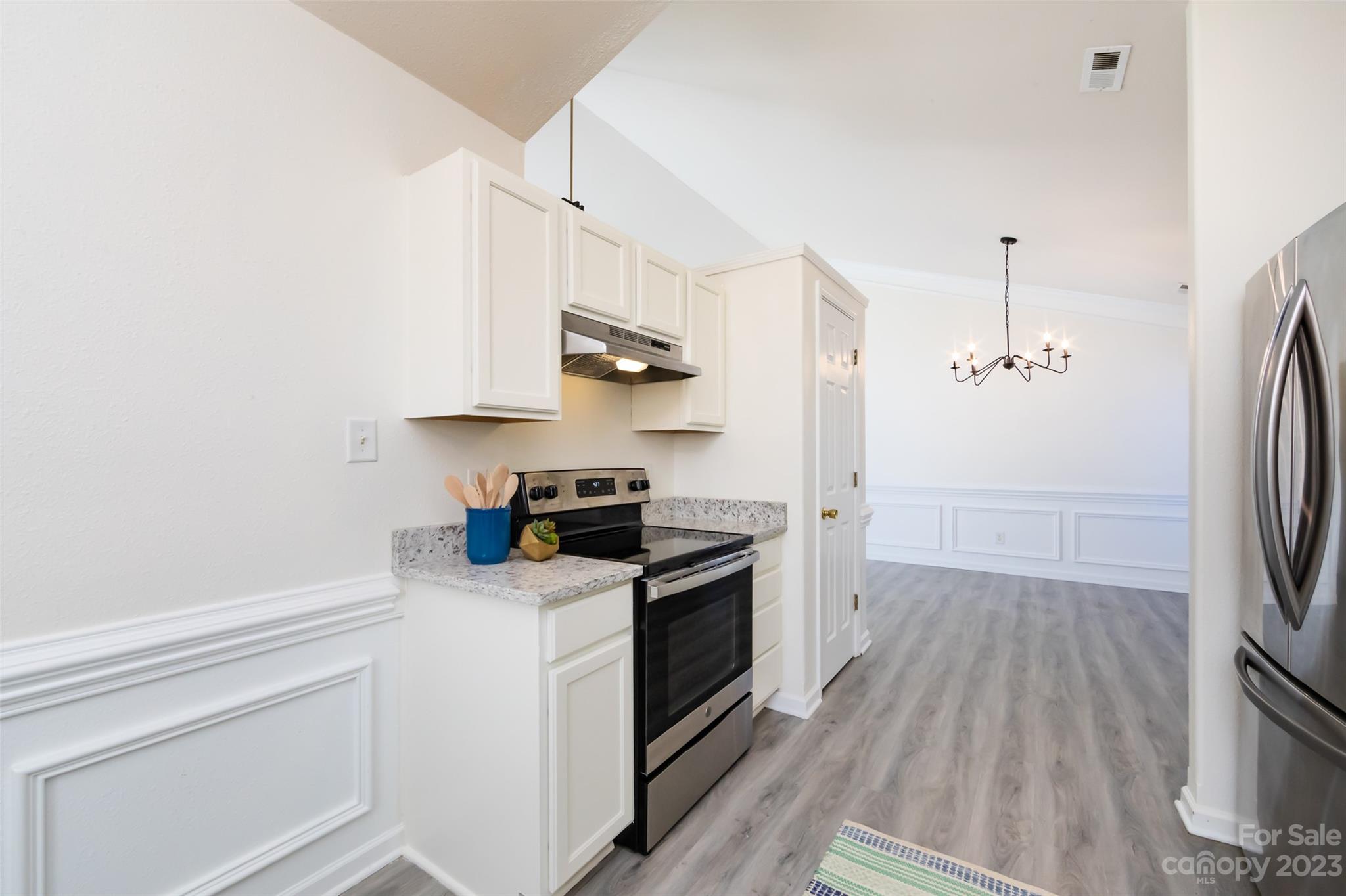 13009 Beddingfield Drive Charlotte, NC 28278 - Photo 14 of 32 a kitchen with stainless steel appliances a sink dishwasher a refrigerator and a stove with wooden floor