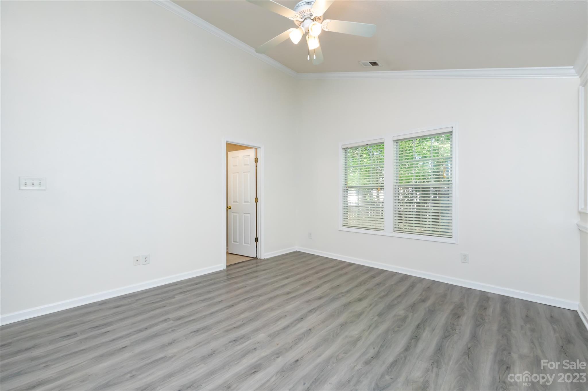 13009 Beddingfield Drive Charlotte, NC 28278 - Photo 17 of 32 an empty room with wooden floor and windows