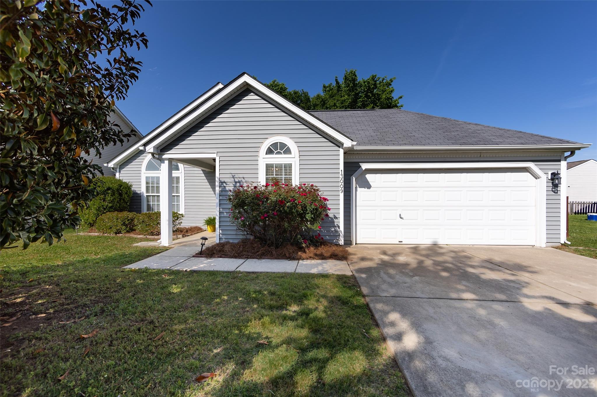 13009 Beddingfield Drive Charlotte, NC 28278 - Photo 2 of 32 a front view of a house with a yard and garage