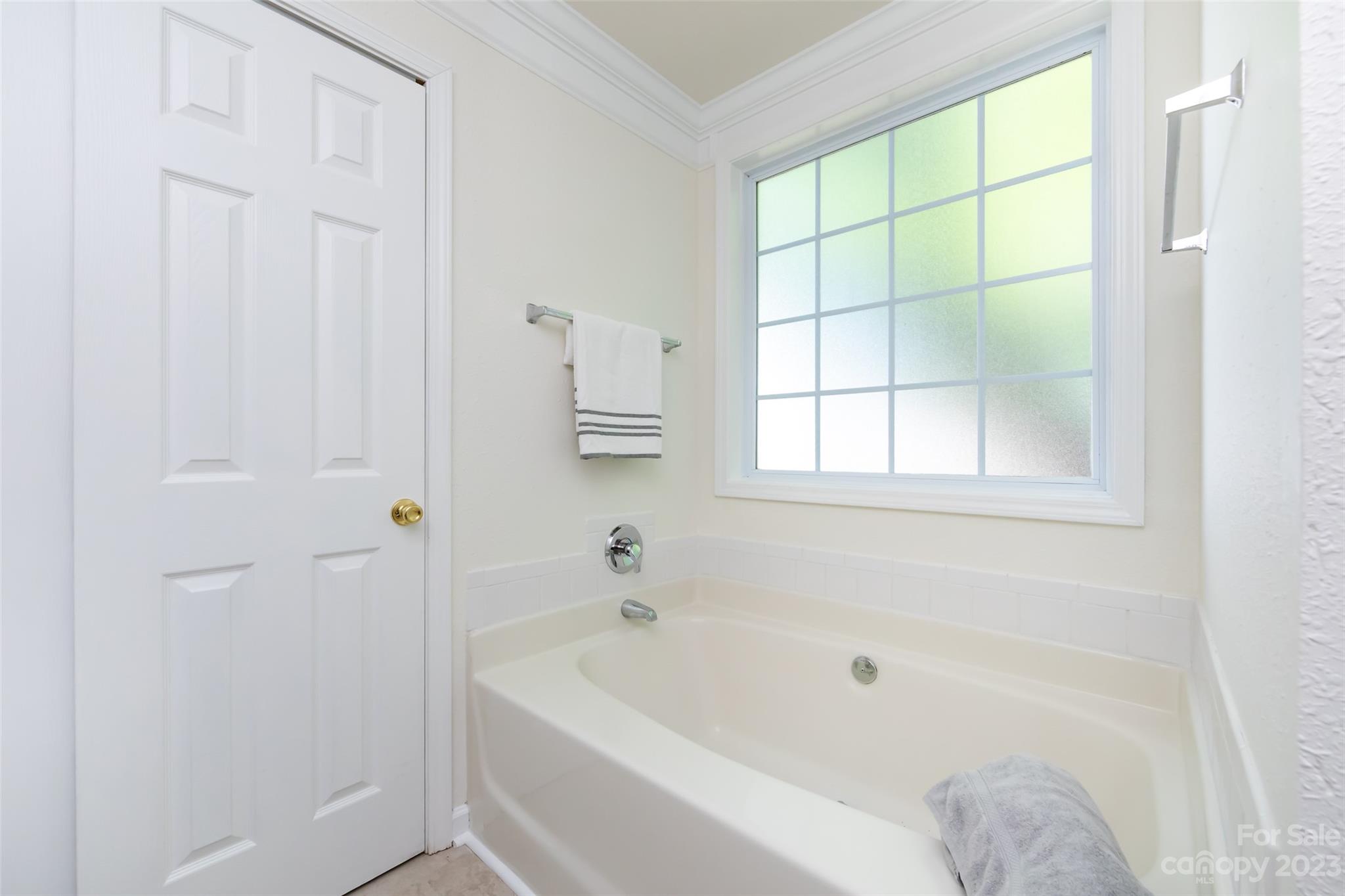 13009 Beddingfield Drive Charlotte, NC 28278 - Photo 22 of 32 a white bath tub sitting next to a window