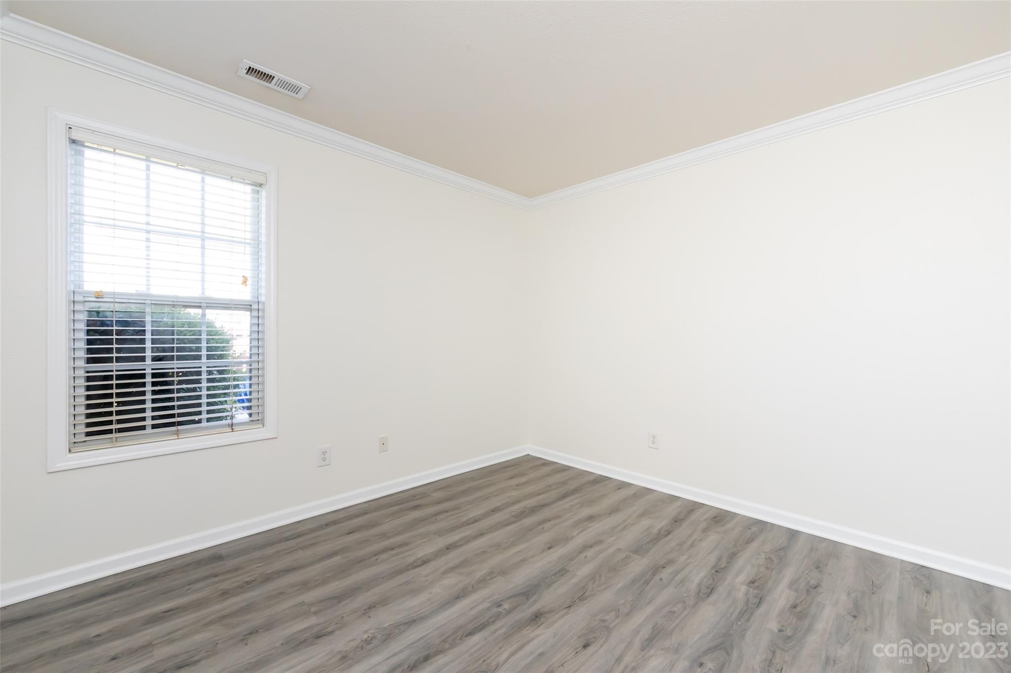 13009 Beddingfield Drive Charlotte, NC 28278 - Photo 24 of 32 a view of an empty room with wooden floor and a window