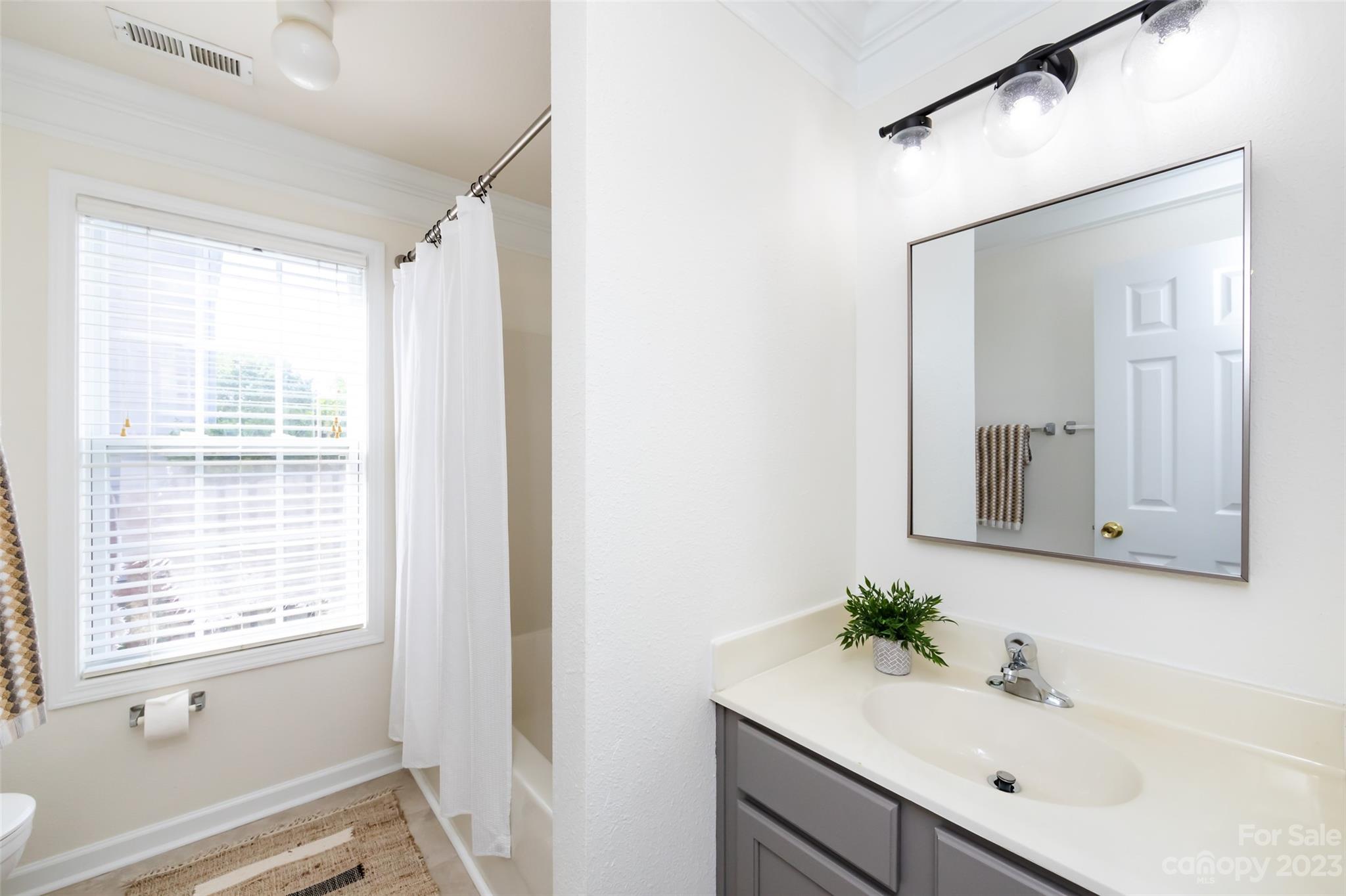 13009 Beddingfield Drive Charlotte, NC 28278 - Photo 25 of 32 a bathroom with a sink vanity granite and a mirror