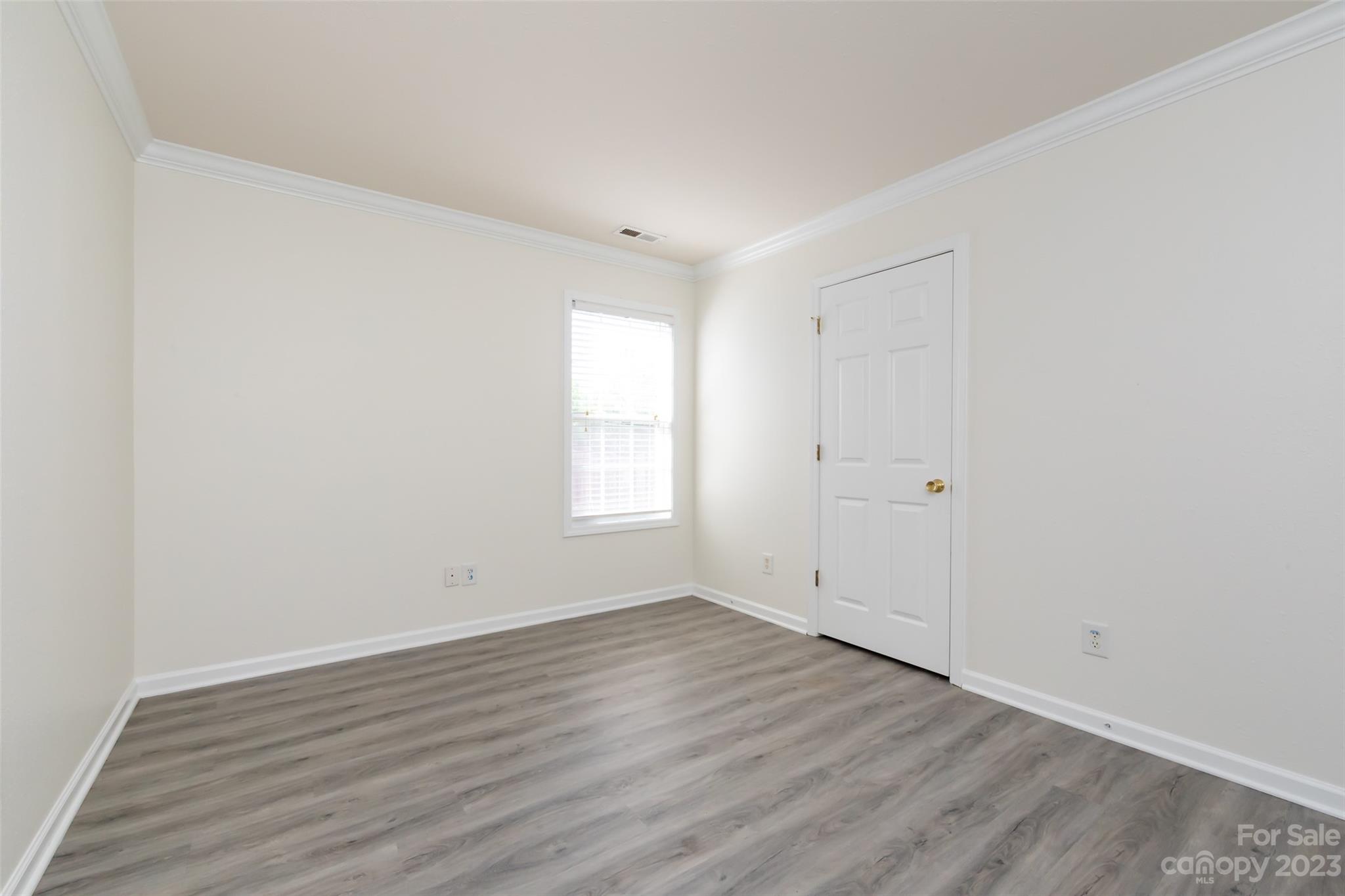 13009 Beddingfield Drive Charlotte, NC 28278 - Photo 26 of 32 an empty room with wooden floor and window