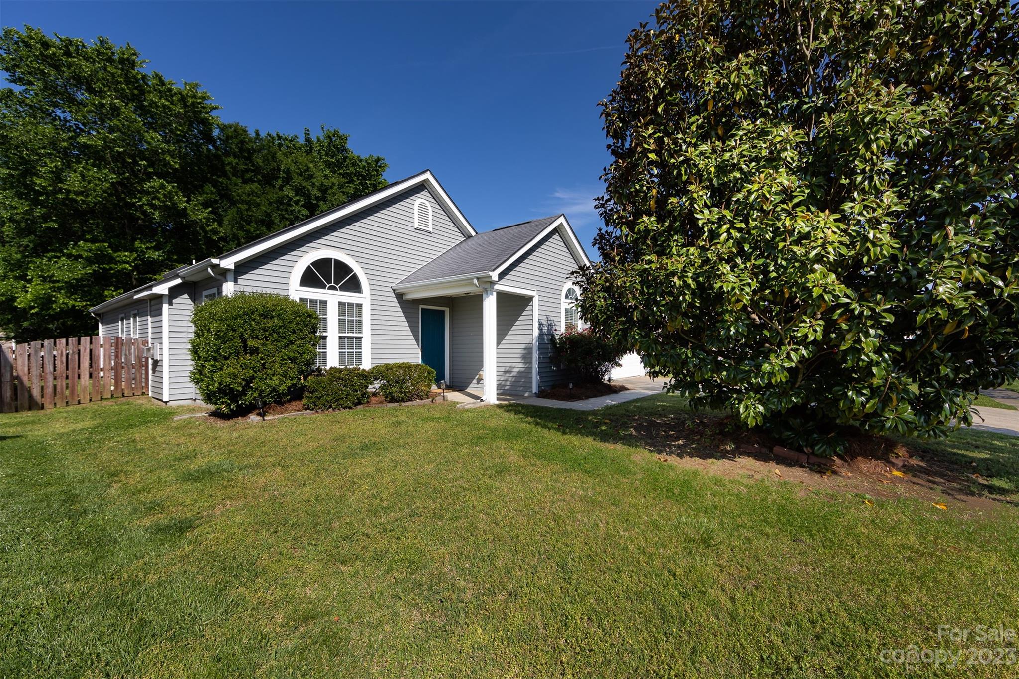 13009 Beddingfield Drive Charlotte, NC 28278 - Photo 3 of 32 a front view of a house with a yard and trees