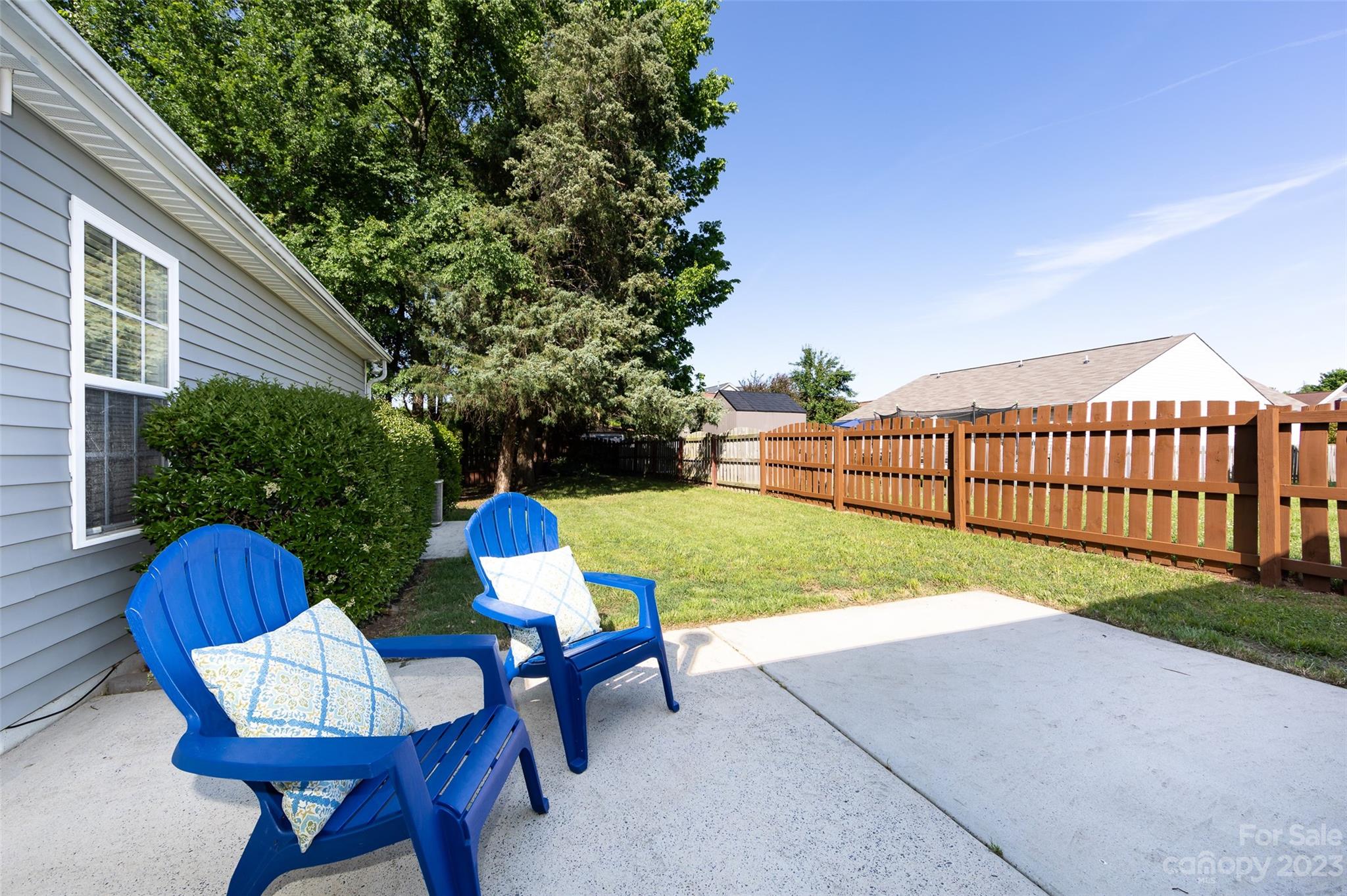13009 Beddingfield Drive Charlotte, NC 28278 - Photo 32 of 32 a view of backyard with table and chairs potted plants and a palm tree