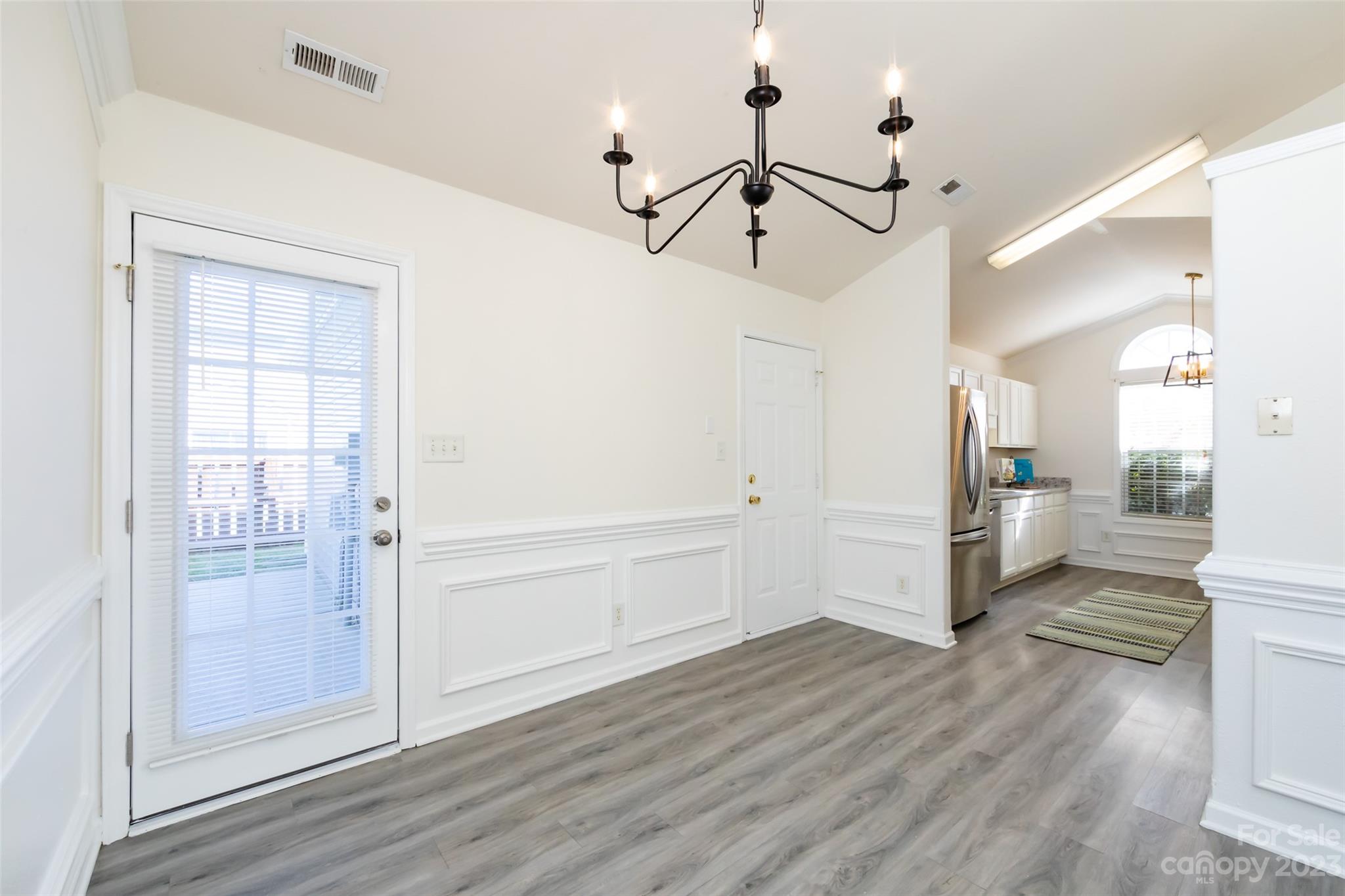 13009 Beddingfield Drive Charlotte, NC 28278 - Photo 8 of 32 a view of a hallway with wooden floor and a living room