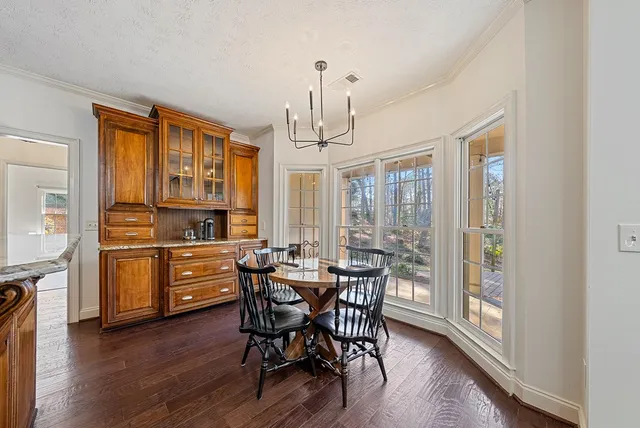 a kitchen with stainless steel appliances kitchen island granite countertop a stove and cabinets