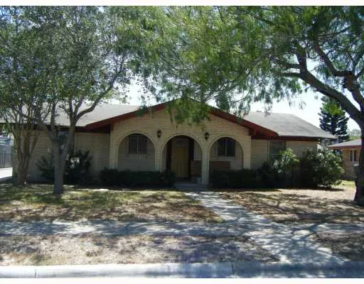 a front view of house with yard and trees
