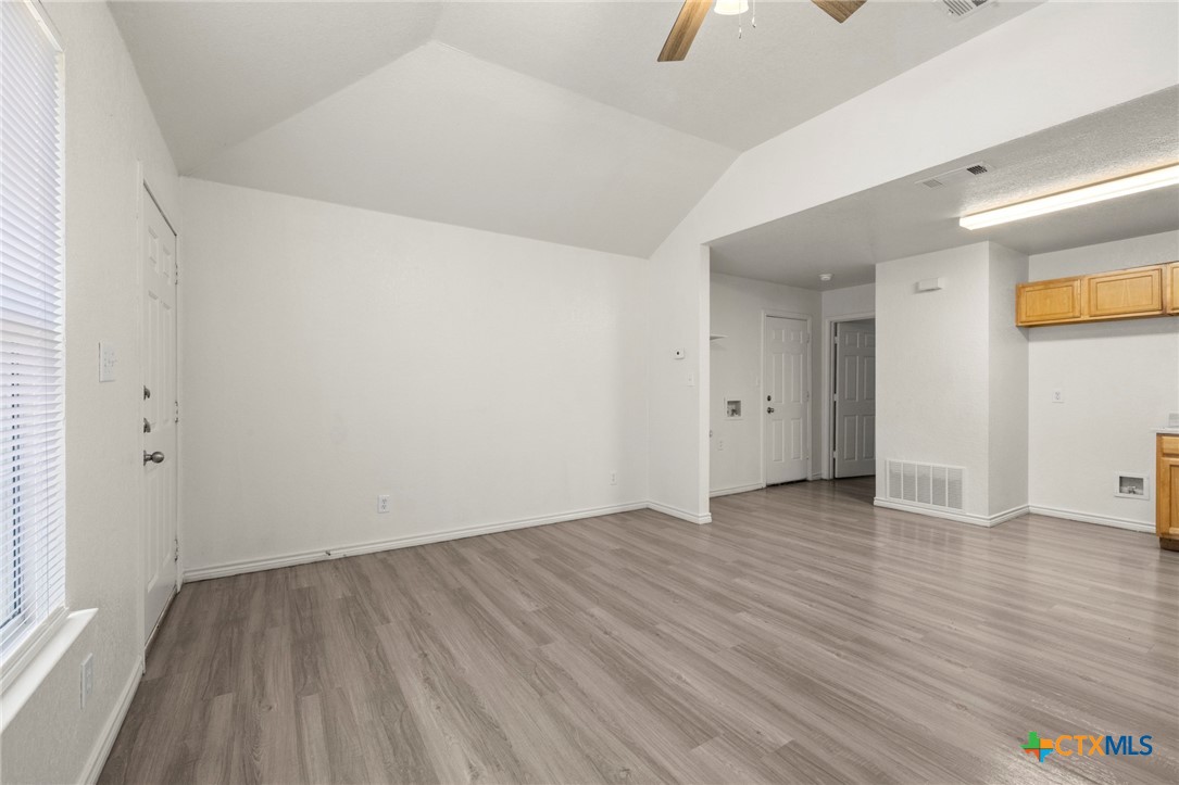 115 North 20th Street Temple, TX 76501 - Photo 2 of 8 an empty room with wooden floor and windows
