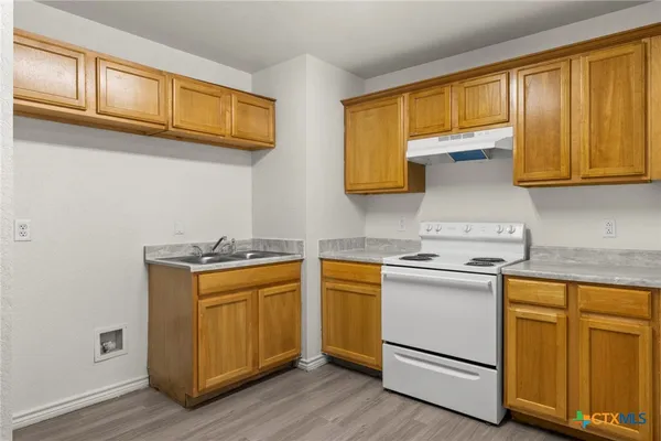 a kitchen with stainless steel appliances granite countertop a sink and cabinets